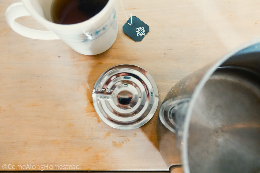 metal boil watcher on table