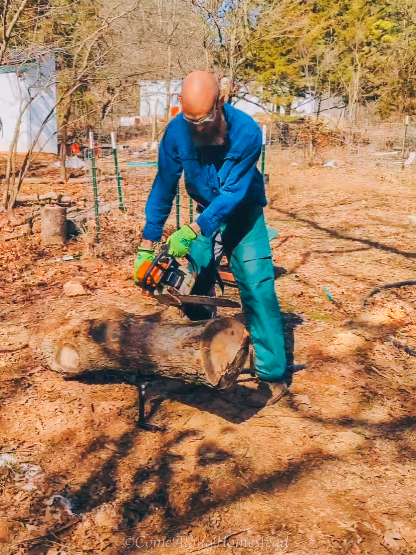 man chainsawing a log
