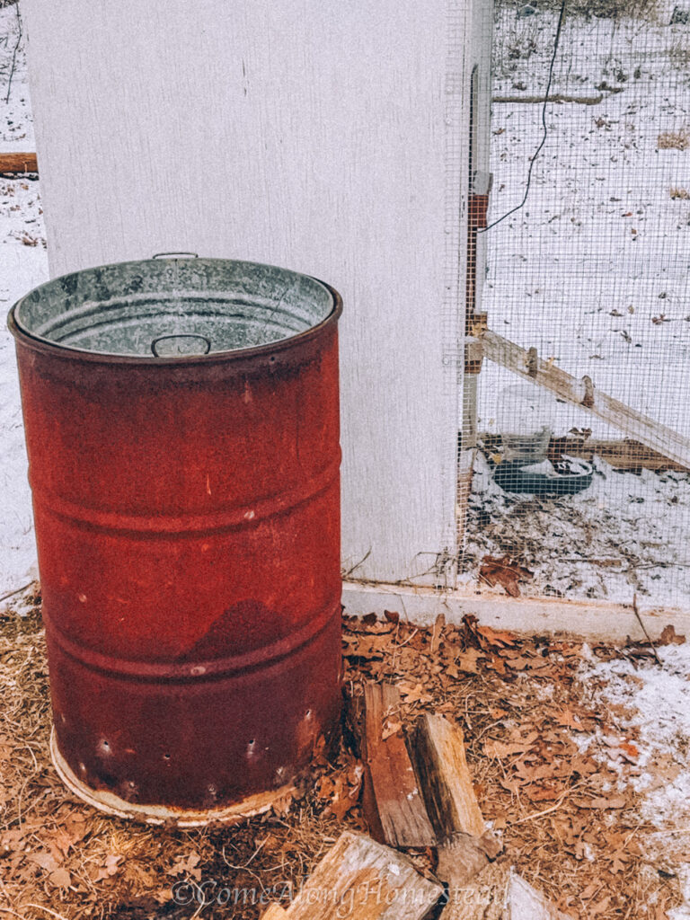 red barrel by a chicken coop
