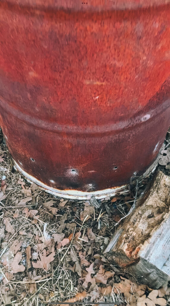multiple holes drilled at the bottom of a burn barrel