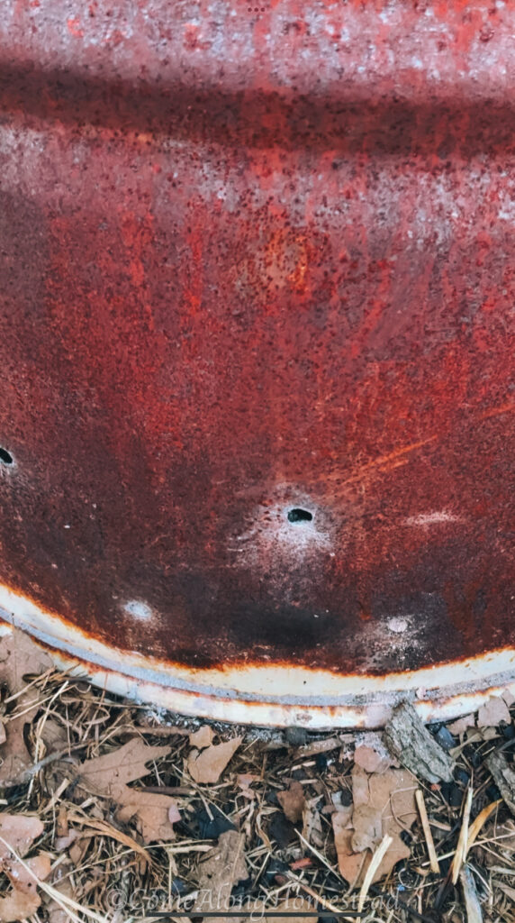 small holes drilled at the bottom of a burn barrel